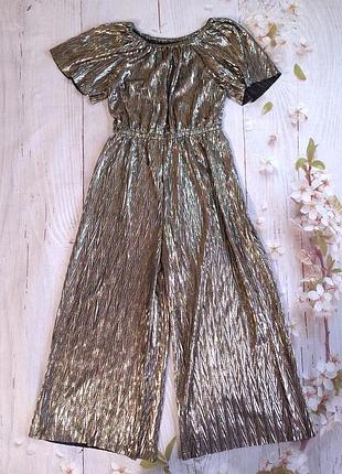 Золотой праздничный комбинезон nutmeg указан 8-9 лет.