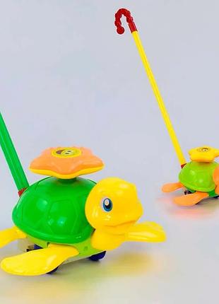 Каталка 0361 (72/2) «черепашка» на палочке с движущимися ножками и погремушкой, 2 цвета, упаковка