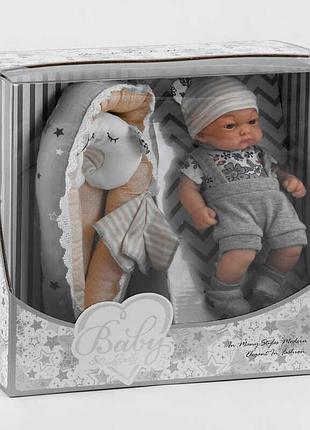 Малыш 219-1 (18/2) высотой 25 см, комплект с комбинезоном, шапочкой, носочками, полотенцем, матрасиком и