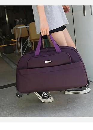 Сумка на колесах дорожня містка 55 літрів водонепроникна з колесами та телескопічною ручкою