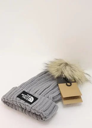Стильна тепла зимова жіноча шапка the north face beanie зі знімним помпоном зі штучного хутра
