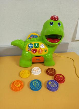 Розвиваюча іграшка музичний динозаврик vtech chomp and count dino green.