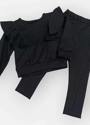 Дитячий трикотажний чорний костюм для дівчинки з рюшами 104 см