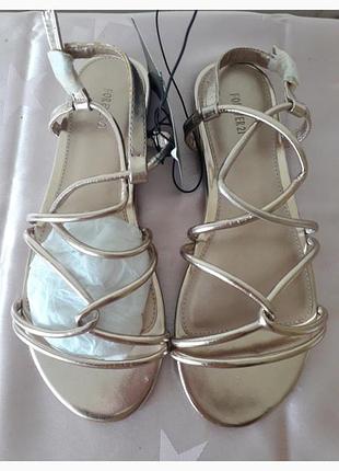 Нові босоніжки літо шкірзам  золотого кольору нові фірмові святкові випускні весілля пляж з біркою греч сандал