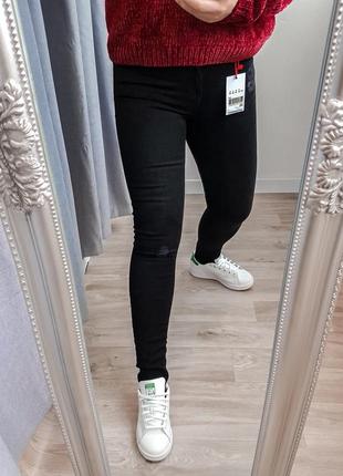 Джинсы скинии с фирменными потертостями