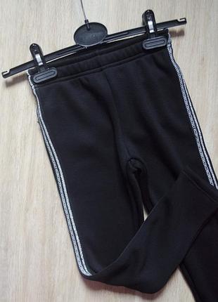 Нові теплі чорні лосіни з срібними лампасами на резинці для дівчинки