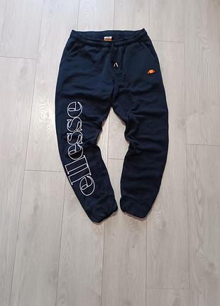 Спортивные штаны ellesse оригинал темносиние с большим лого
джоггеры ellesse с крупным принтом стана идеальны
мужские спортивные штаны ellesse размер м l