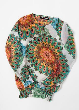 Яскрава блуза desigual з фірмовим, насиченим принтом у стилі boho. модель виконана з легкої, напівпрозорої тканини, прикрашена великими,
