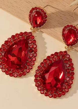 Сережки золотистого кольору з червоними камінцями