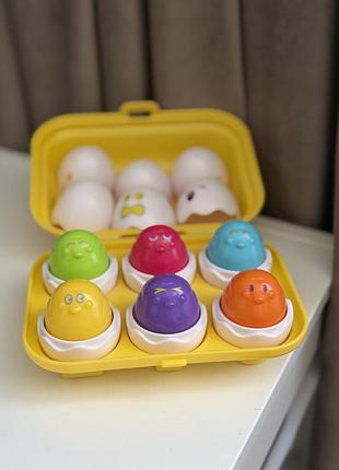 Розвиваюча іграшка-сортер tomy (toomies) "кумедні яйця" у жовтому лотку