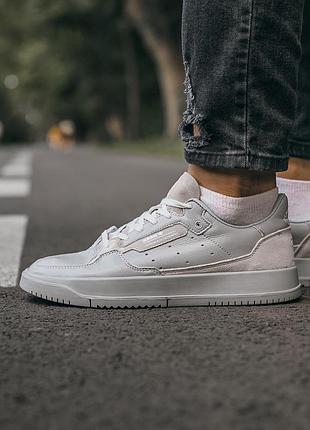 Adidas brand with the 3 stripes
“all grey”