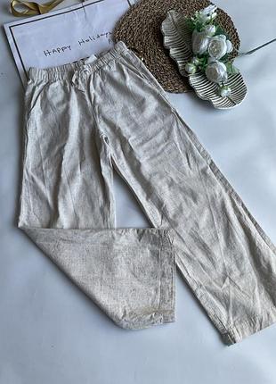 Бежеві лляні штани h&m мають еластичний пояс із зав'язками та вільний крій
