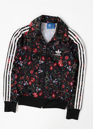 Оригінальна, жіноча, спортивна олімпійка adidas originals із яскравим, квітковим принтом. модель виконана у класичному стилі бренду з