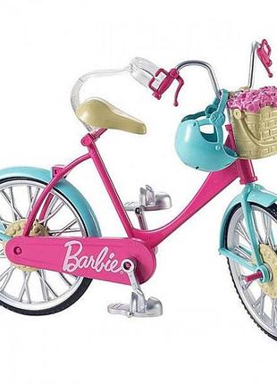 Рожевий велосипед barbie, модель dvx55, який має бірюзові крила та сріблясті деталі.