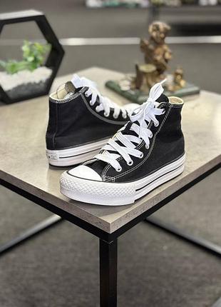 Кеди converse chuck taylor all star eva lift hi чорного кольору з білою товстою підошвою та білими шнурками.