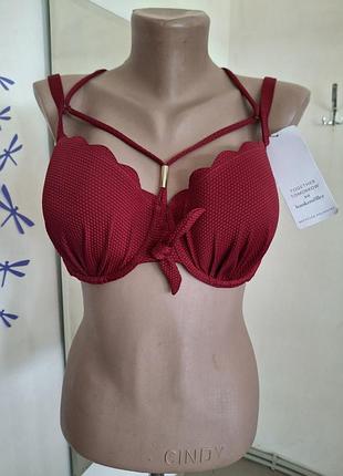 Бордовый раздельный купальник бренда hunkemöller выполнен из фактурной ткани и имеет декоративные кисточки на завязках. 75 f