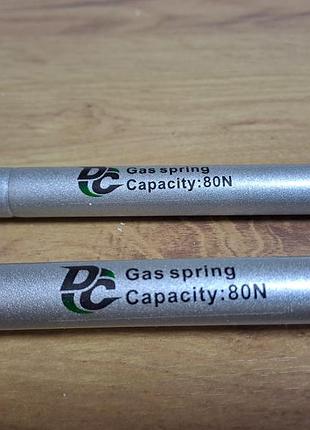 Газовый амортизатор для нижнего открывания 60n, длина 18 см, ширина 2см,новый.