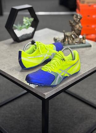 Бігові шиповки asics hypersprint 6, виконані у яскравому неоново-жовтому кольорі з синіми деталями.