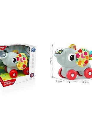 Каталка-сенсорная игрушка he 8093 в виде слоника с шелестящими и гремящими элементами