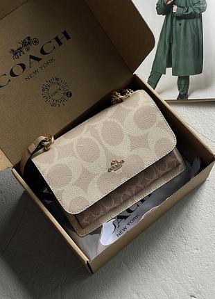 Жіноча сумка coach mini klare crossbody in signature canvas через плече молочний коуч