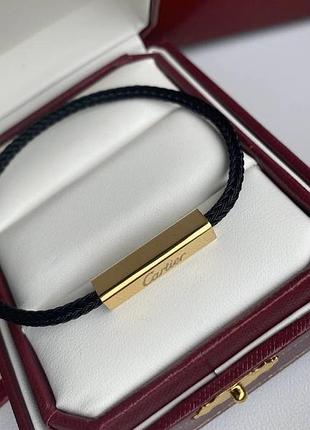 Браслет cartier в золотом металле на черном шнуре с металлической застежкой (унисекс)