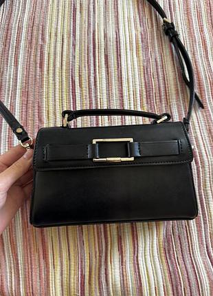 Чорна сумка zara  невеличка та зручна сумка. має 2 основні відділи та маленьку внутрішню кишеньку.  є незначні подряпини на фурнітурі.