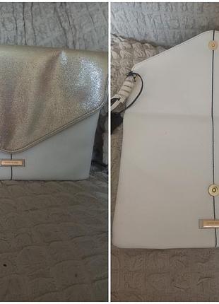 Новый стильный клатч-конверт белого с золотистым цвета, от бренда river island с откидным клапаном и металлической деталью с логотипом.