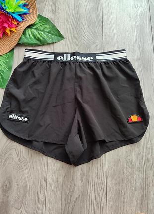 Чорні спортивні шорти ellesse з еластичним брендованим поясом та фірмовими патчами з логотипами на штанинах розмір