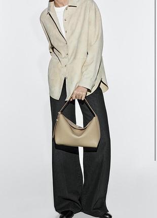 Сумка massimo dutti бежевого кольору з  натуральної  шкіри