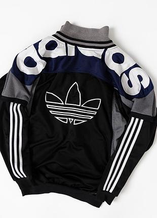 Вінтажна, чоловіча, спортивна олімпійка adidas у класичному ретро-дизайні. основний колір чорний, доповнений сірими та темно-синіми вставками, фірмо