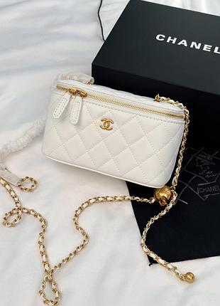 Chanel mini vanity case in white lambskin with gold-tone hardware and ball charm chain