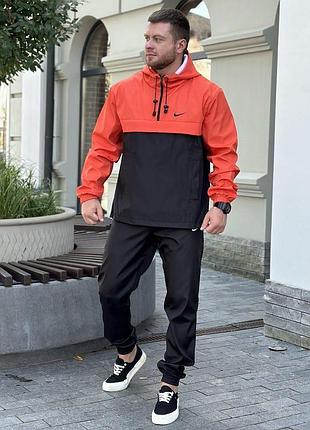 Стильный демисезонный анорак nike чёрно-оранжевый без узоров и принтов, мужская ветровка с регулировкой капюшона