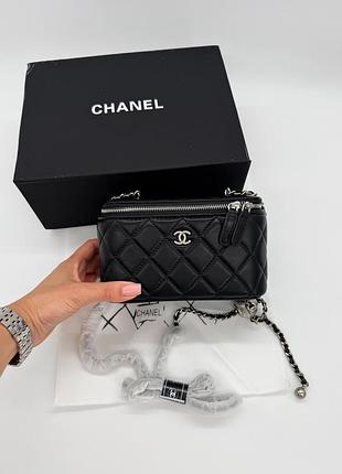 Chanel mini vanity case in black lambskin with silver-tone hardware and ball charm chain