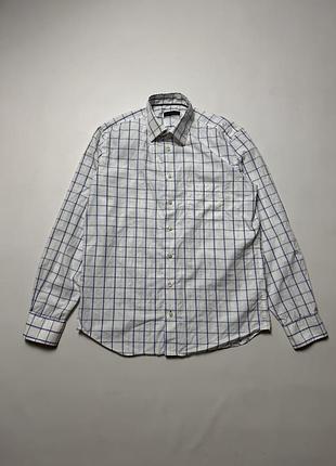 Tommy hilfiger men's long sleeve button-up shirt in white with blue and light blue grid check pattern. features a classic collar, chest pocket, textur