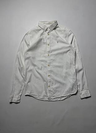 Men's classic lacoste long sleeve button-up shirt in cream/beige with blue grid check pattern. designed in france and made in peru from 100% soft cott