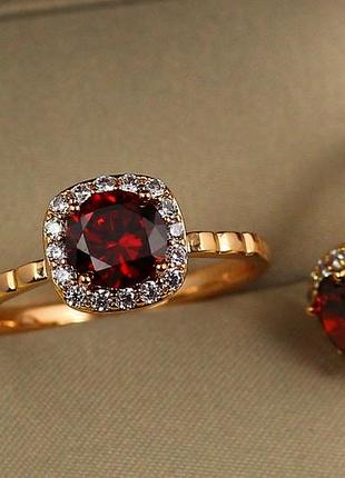 Кольцо xuping jewelry красный камень в ободке из белых фианитов р 19 золотистое