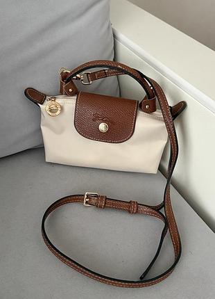 Крос-боді для жінок longchamp le pliage pouch mini бежева, 17х11х5,5 см