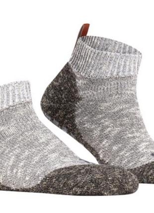 Сірі меланжеві домашні шкарпетки falke lodge homepad із характерними коричневими петельками на п'ятах.