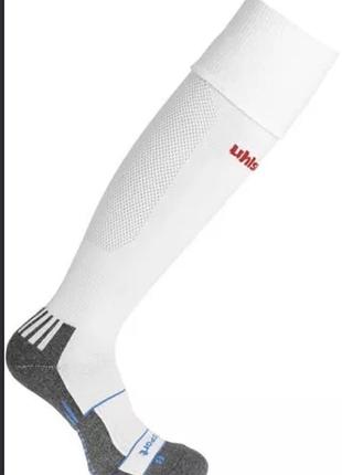 Білі футбольні гетри бренду uhlsport, зокрема модель uhlsport team pro player socks із сірими стопами та червоним логотипом.