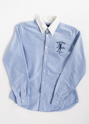 Жіноча сорочка ralph lauren у світло-блакитному кольорі з контрастним, білим коміром. модель має класичний крій на ґудзиках, довгі рукави з манжетами