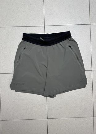 Спортивні чоловічі шорти gymshark джимшарк fit elite 5" shorts для залу бігу фітнесу та тренувань з внутрішніми шортами кишені хакі зелені xs оригінал