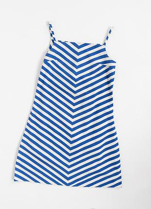 Виразна, вінтажна сукня marimekko з характерним, графічним дизайном у синьо-білу смужку. геометричний малюнок утворює динамічний v-подібний ритм по в