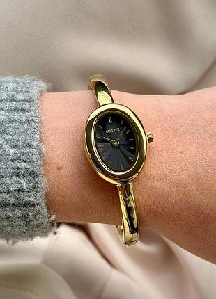 Годинник золотистий з чорним овальним циферблатом burker diana gold black