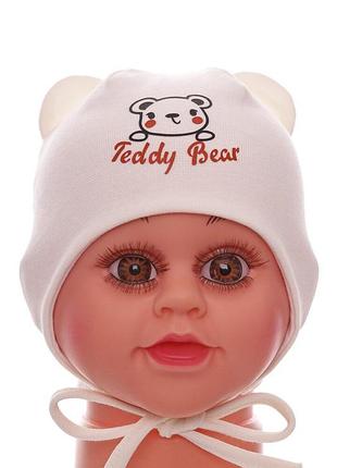 Шапка на зав'язках для хлопчика подвійний трикотаж teddy bear молочна