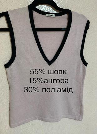 В'язаний жіночий жилет / жилетка без рукавів з v-подібним вирізом.