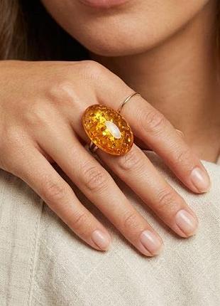 Овальна каблучка бренду new look із великою вставкою теплого бурштинового / медового кольору із мерехтливими вкрапленнями ..р.s