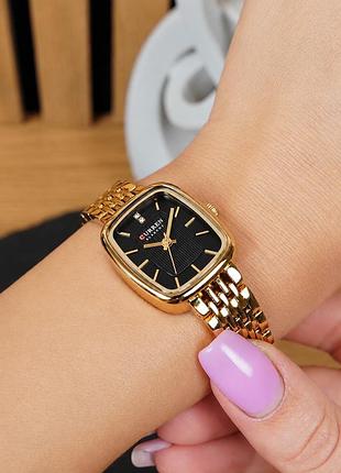 Жіночий годинник curren 9093 gold-black з кварцовим механізмом, сталевим корпусом та металевим ремінцем