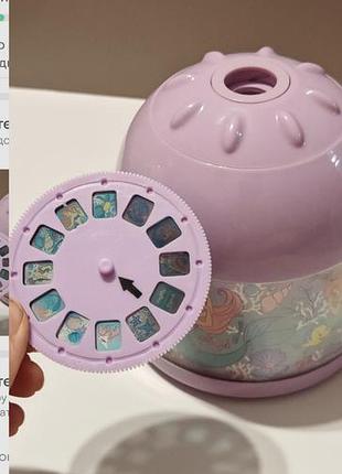 Фиолетовый детский проектор-ночник smiggle disney princess ariel light projector с круглым сменным слайд-диском с изображениями в стиле «русалочки».