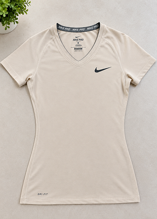 Жіноча спортивна футболка nike pro бежева з v-подібним вирізом та технологією dri-fit