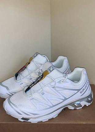 Белые кроссовки salomon xt-6 с серыми элементами.